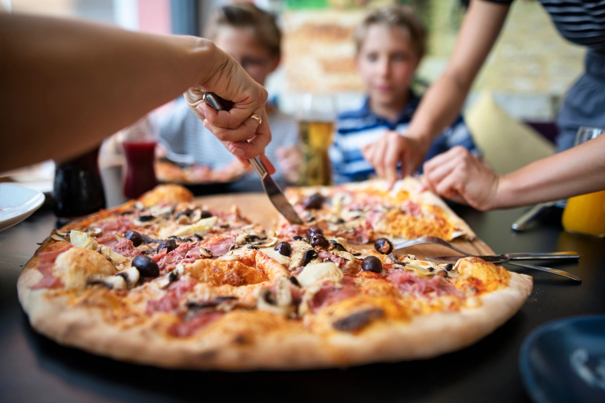 family enjoying pizza restaurant